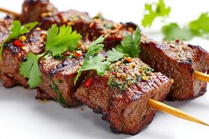 Realistic grilled beef skewers with coriander leaves on white background photo