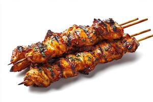 Juicy grilled BBQ chicken skewers served on white plate photo