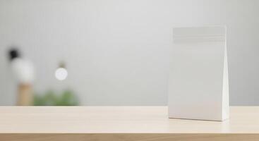 White paper bag mock up on wooden table with blurred background photo