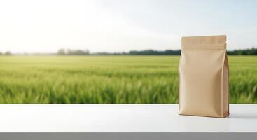 A bag of coffee on a table in front of a green field photo