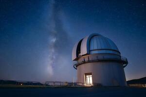 Astronomical Observatory Under Starry Night Sky with Milky Way Brightly Visible photo