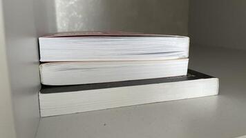 A stack of books on a shelf photo