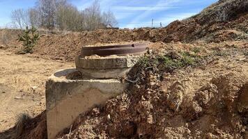 manhole cover sticks out from under the ground photo