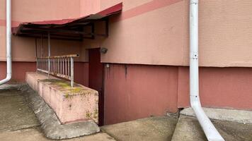 A white pipe on the side of a building photo