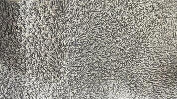 A close up of a gray rug with a white background photo