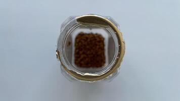 Empty jar of instant coffee close-up. The last grains of coffee are lying at the bottom of the jar. Diet food, nutrition, and clean eating themes, this image is ideal for food blogs, wellness articles, and healthy lifestyle promotions. High-resolution, is photo