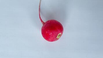 Fresh organic red radish on a light background create a healthy, colorful composition perfect for food blogs, healthy eating concepts, or vegetarian recipes. Ideal for promoting farm produce, vegan lifestyle, and clean eating visuals photo