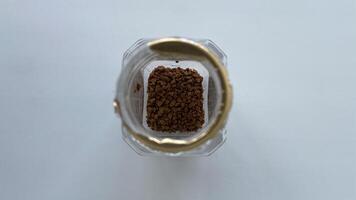 Coffee beans in a jar on a white surface photo