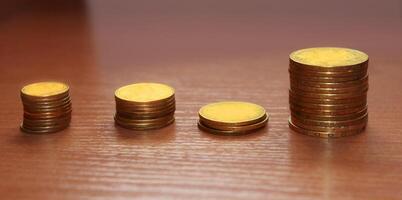 Stack of coins on wooden table. Financial, Business Growth concept. photo