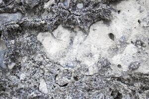 Ancient Stone Wall. Abstract Cement Background. The Texture of the Ancient Stone From Pebbles, Stones and Bricks Close-up photo