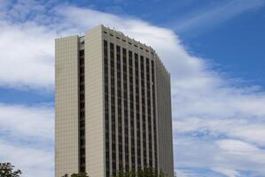 View of a Modern Office Building Against the Background of the Sky Extending Towards the Clouds photo