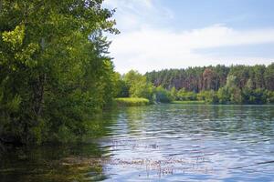 Summer landscape, Marble Canyon, Ukraine. Scenic view of a landscape with an emerald lake and rocks in the middle of a coniferous summer forest in Zhytomyr, northern Ukraine. Zhytomyr canyon photo