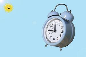 Retro Alarm Clock. Close up One Classic Alarm Clock on a Blue Background photo