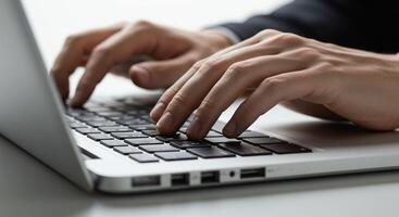 Close-up of hands typing on a laptop photo