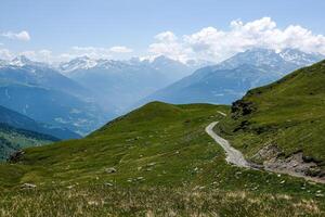 View of a path and the mountains of the Haute Tarentaise at an altitude of over 2000 meters in the Alps in Savoie photo