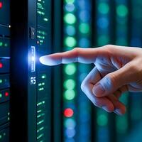 Hand Pressing Button on Server Rack Representing Data Center Access and Security photo