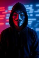 Hacker in Guy Fawkes Mask with Red and Blue Code Background Representing Cybercrime photo