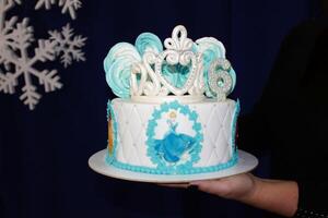 Sweet cake with a crown on a black background. photo