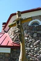 a wooden cross on a stone wall photo