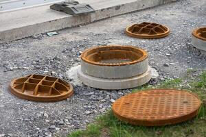 Manhole cover open in street and repair of roads. The use of manholes. Improvement of the city. photo