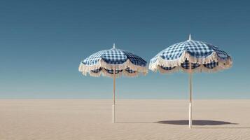 Two Blue and White Umbrellas Stand on a Sandy Landscape Under a Clear Sky at Midday photo