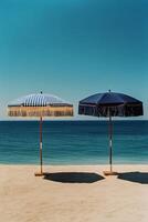 Beach Umbrellas Provide Shade on Sandy Shore Under Clear Blue Sky in a Serene Coastal Setting photo