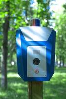 Panic alarm for call to police, emergency button in public park. photo