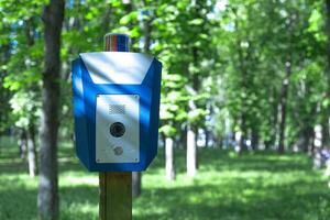 blue box with alarm button in the park to call the police photo