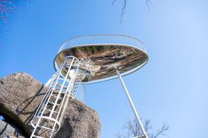 Located near Tanvald in the Jizera Mountains, Sipka lookout platform provides breathtaking panoramic views. Visitors can climb the stairs to enjoy the serene landscape on a clear day. photo