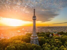 Tower overlooking city at sunset photo