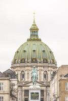 Frederik's Church, also known as the Marble Church, features an impressive dome and the equestrian statue of King Frederick V, set in Amalienborg Square in Copenhagen. photo
