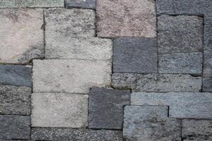 Close-up of interlocking stone blocks with various shades and textures. photo