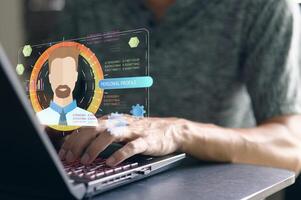 Person Using Laptop with Digital Personal Profile Concept Display photo