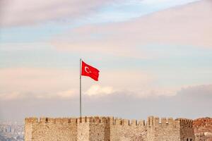Turkish Flag Waves Over Ancient Fortress Walls photo