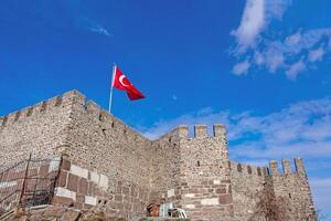 Turkish Flag Waves Over Ancient Stone Castle Majestic View photo