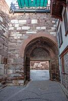 Ancient Stone Archway Exploring Historical Turkish Architecture in a Cobblestone Alleyway photo