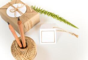 Gift box wrapped in the kraft paper and rustic hemp as natural rustic style photo