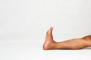 A Single Leg on a White Background in a Straight Line Showing the Toes Raised photo