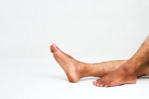 Close-up of a Person's Legs and Feet Resting on a White Surface in Relaxation photo