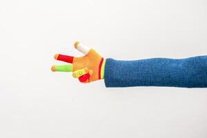 A playful gesture with a colorful knitted hand, symbolizing peace and vibrancy photo