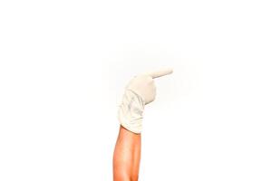 Hand in medical glove pointing to the right, isolated on a white background ready for your text or design element photo