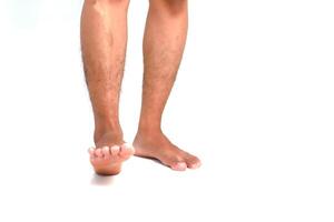 Man stands showing legs and feet on a white background for medical or health care concept showcasing skin or foot problems photo