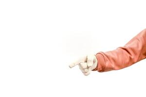 A person's arm pointing with a gloved hand towards the left side of the frame on white photo
