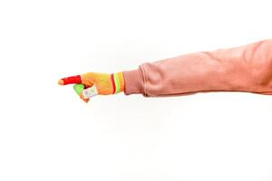 A person's arm and hand pointing to the left while wearing a colorful finger puppet sleeve against a white background photo