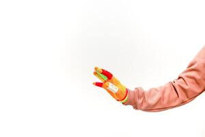 A colorful gloved hand with a bandage reaching out on a white background creates a playful and vibrant visual photo