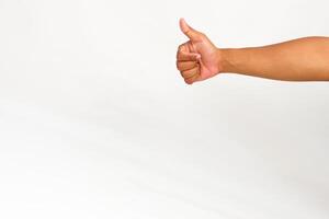 Hand gesture showing thumbs up on white background, concept of approval and agreement, successful sign photo