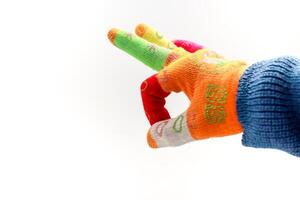 Close-up of a person wearing a colorful gardening glove with fingers extended against a white background photo