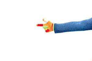 Colorful sock puppet hand gesture in the shape of a pistol pointing to the left photo