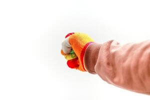 Close-up of a fist wearing a colorful work glove against a bright white background, representing protection photo