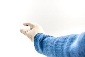 Hand in sterile glove holding or picking something on white background with space photo